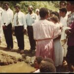 Rungi Pingi baptised as Steven Kual, ETS Pioneer watches on.